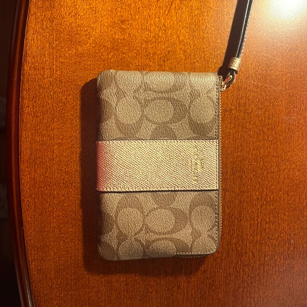 Brown Coach wristlet with two pockets on the inside